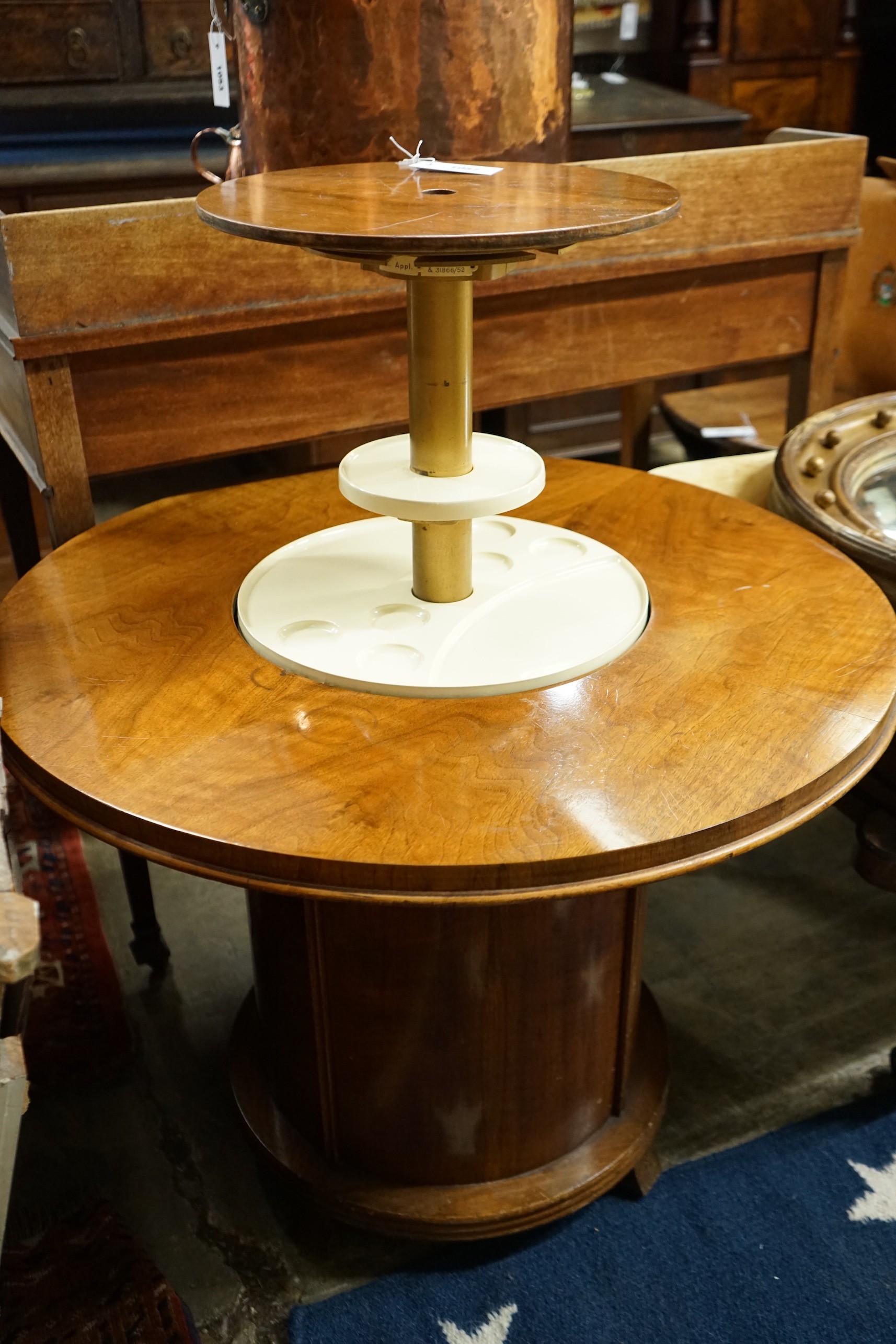 An Art Deco style circular walnut Patent Pop-up drinks table, diameter 80cm, length 92cm extended